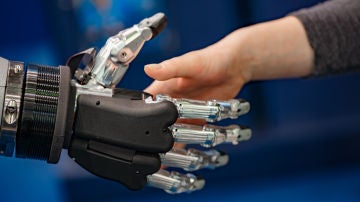 Mano robótica estrechando mano humana